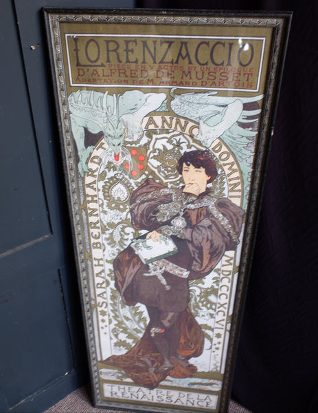 A framed vintage-style poster featuring an illustrated figure in Renaissance clothing with decorative text, including 'LORENZACCIO' at the top and 'ANNO 1599' across the center, photographed leaning against a dark surface.