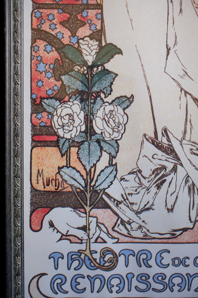 Close-up of an Art Nouveau style illustration featuring white flowers on a stem with green leaves, set against a vintage-style background with decorative text and linework.